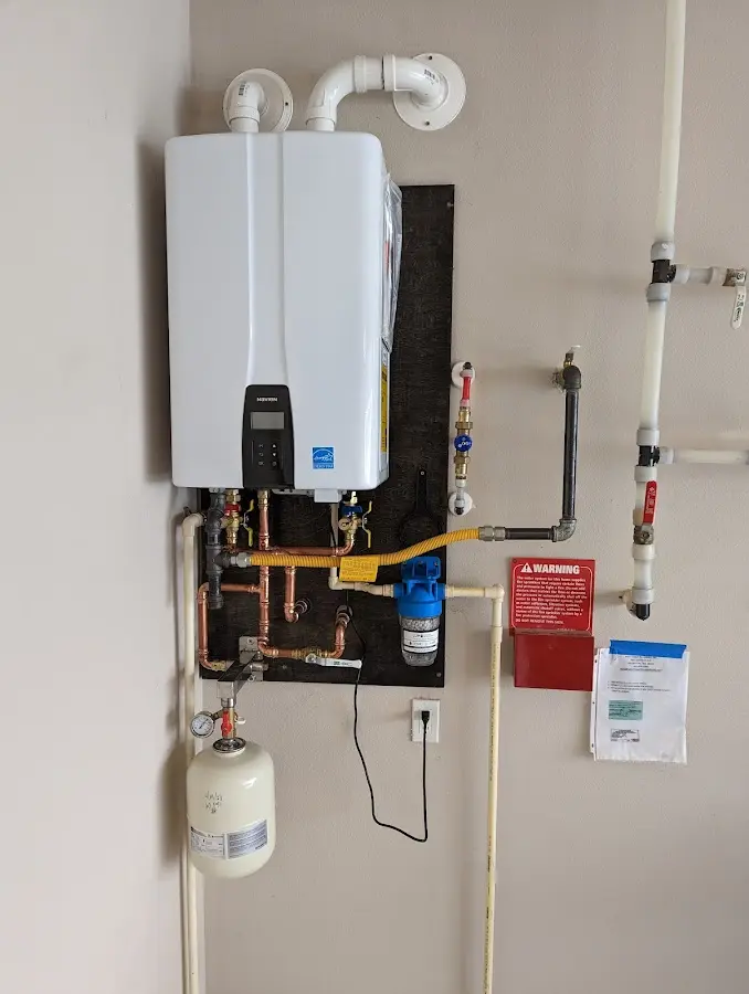 Professional plumber installing copper piping in a Goshen home